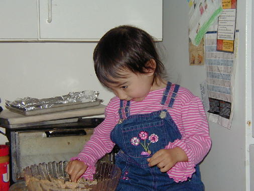 Helping Mommy make the cake.
