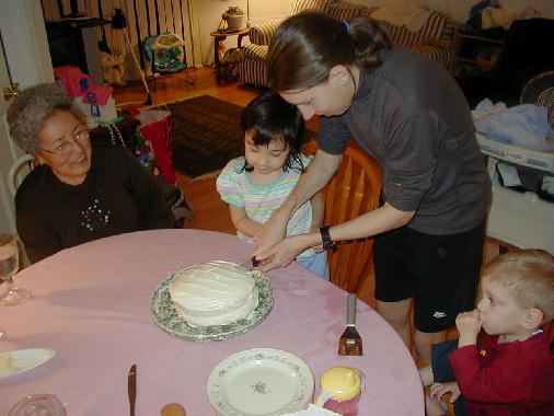 Eileen cuts the first slice.