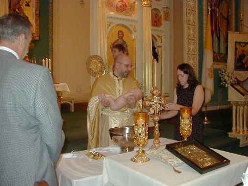 Father Ron prepares to baptize Michael.